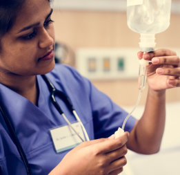 nurse checking IV bag