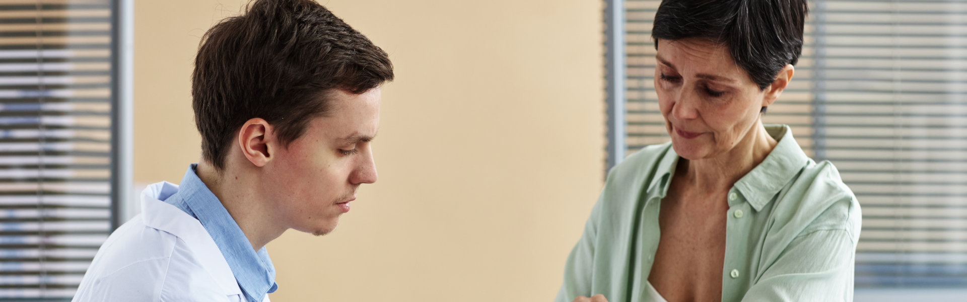 doctor checking woman hand
